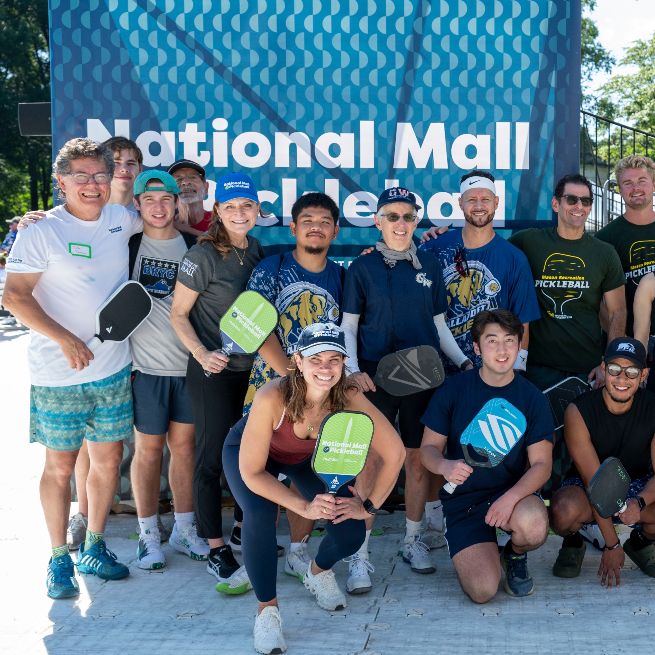 Group shot of picklers in front of Tournament branding.