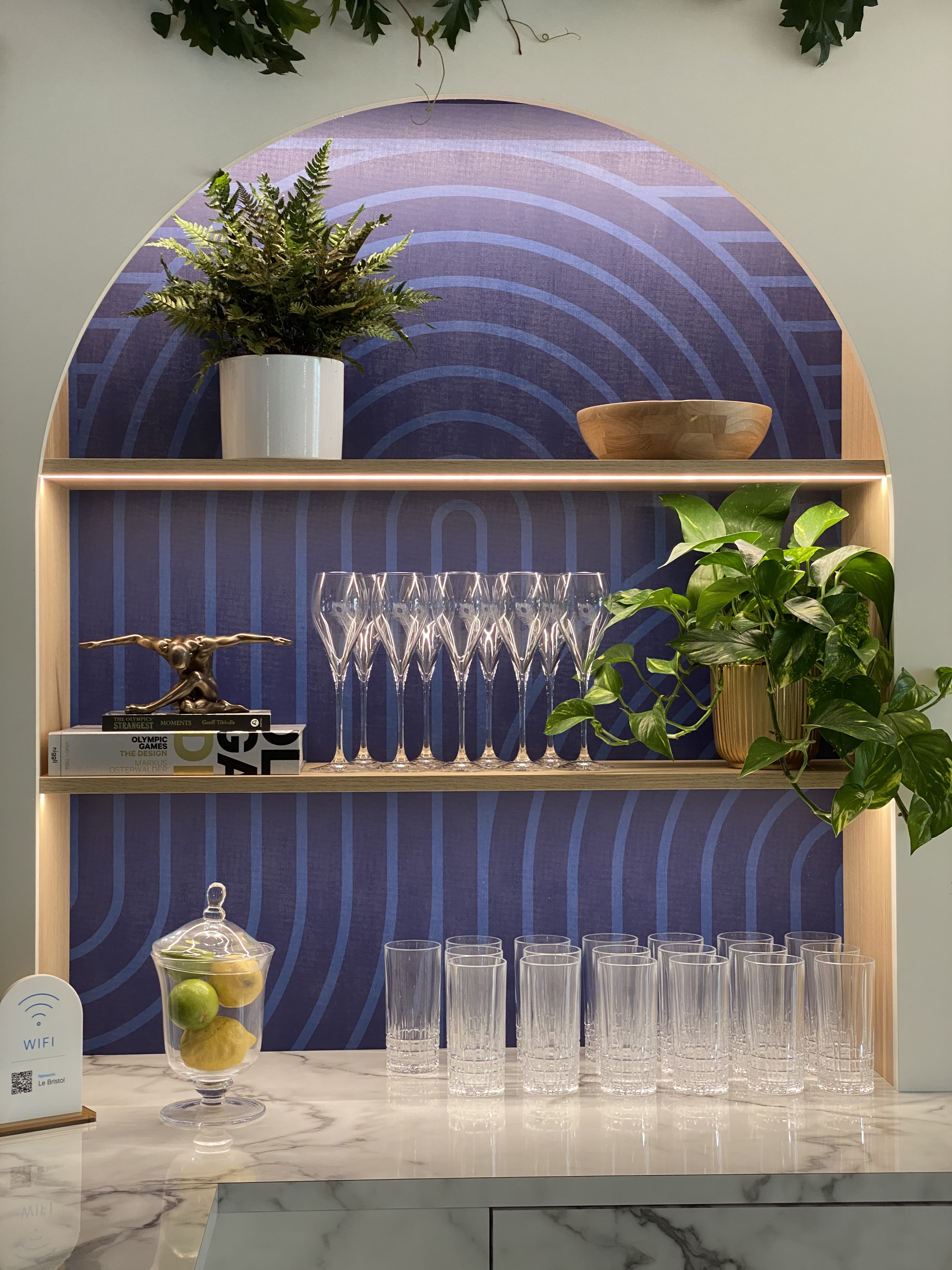Arched shelf display with cups and plants